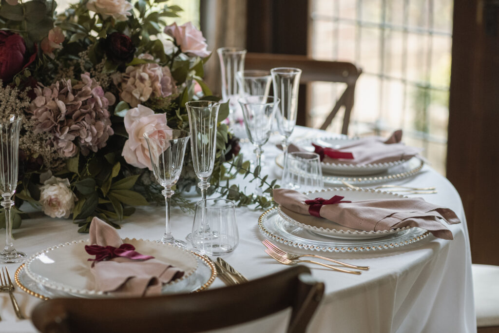 The wedding tables at Ramster Hall dressed for a winter wedding with delicate shades of blush rose.