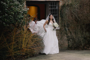 Bride walking down the aisle at Ramster Hall during a Christmas wedding venue celebration