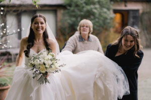 Bride arriving at Ramster Hall during a Christmas wedding venue celebration
