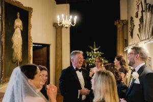 Guests enjoying Ramster Hall for a festive winter wedding in a Surrey country house setting