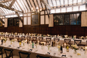 Long banquet tables styled for a Christmas wedding venue reception at Ramster Hall