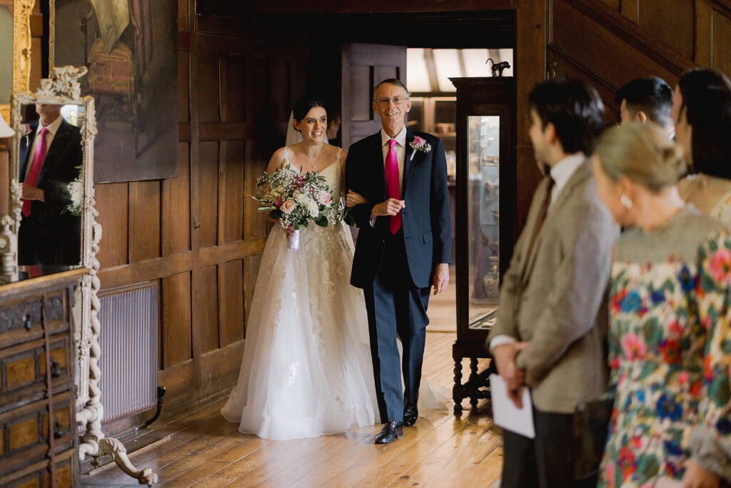 Bride walking down the aisle at a historic country house wedding venue