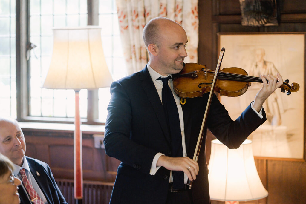 Bride's brother plays violin at her wedding venue in Surrey