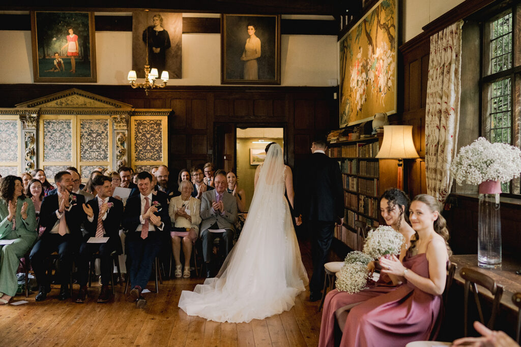 Couple leaving after their ceremony at Ramster Hall