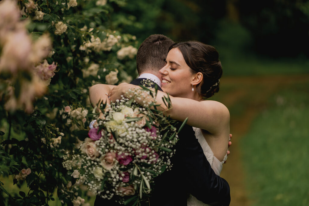 A bride and groom in the garden at Ramster Hall