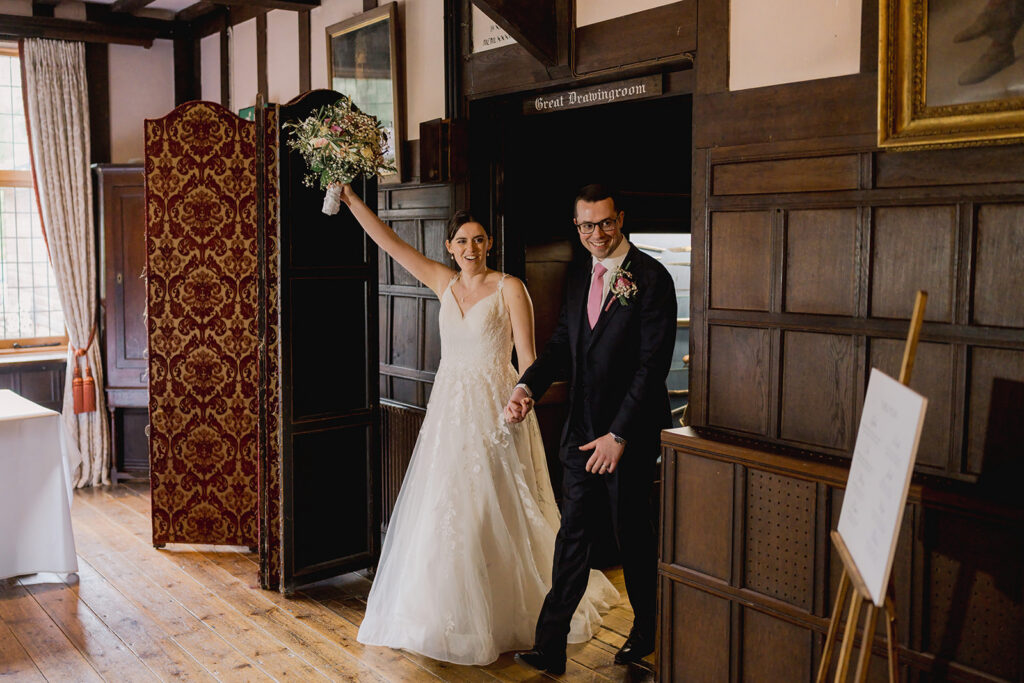 Bride and groom arriving at their wedding breakfast