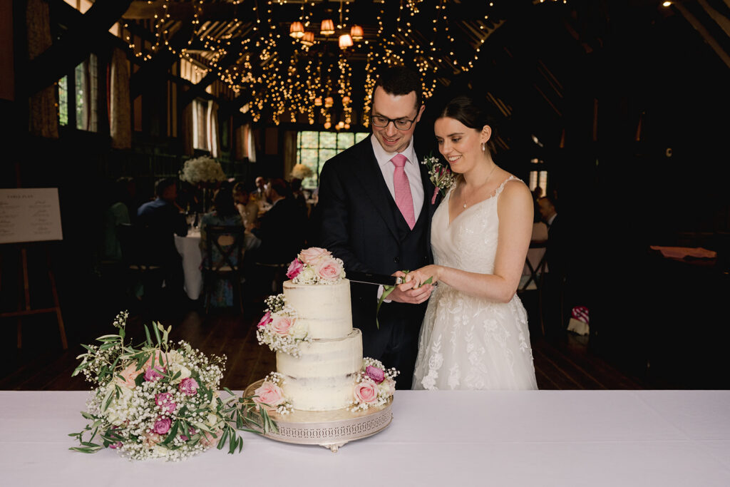 Cake cutting at an elegant Surrey wedding venue
