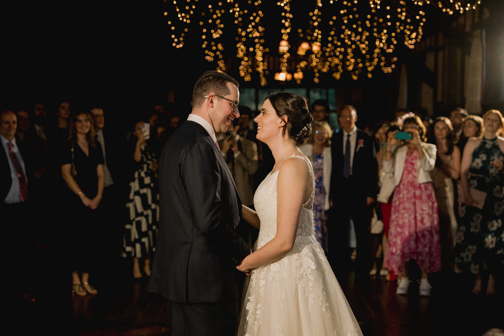 Romantic first dance at a wedding venue with fairy lights